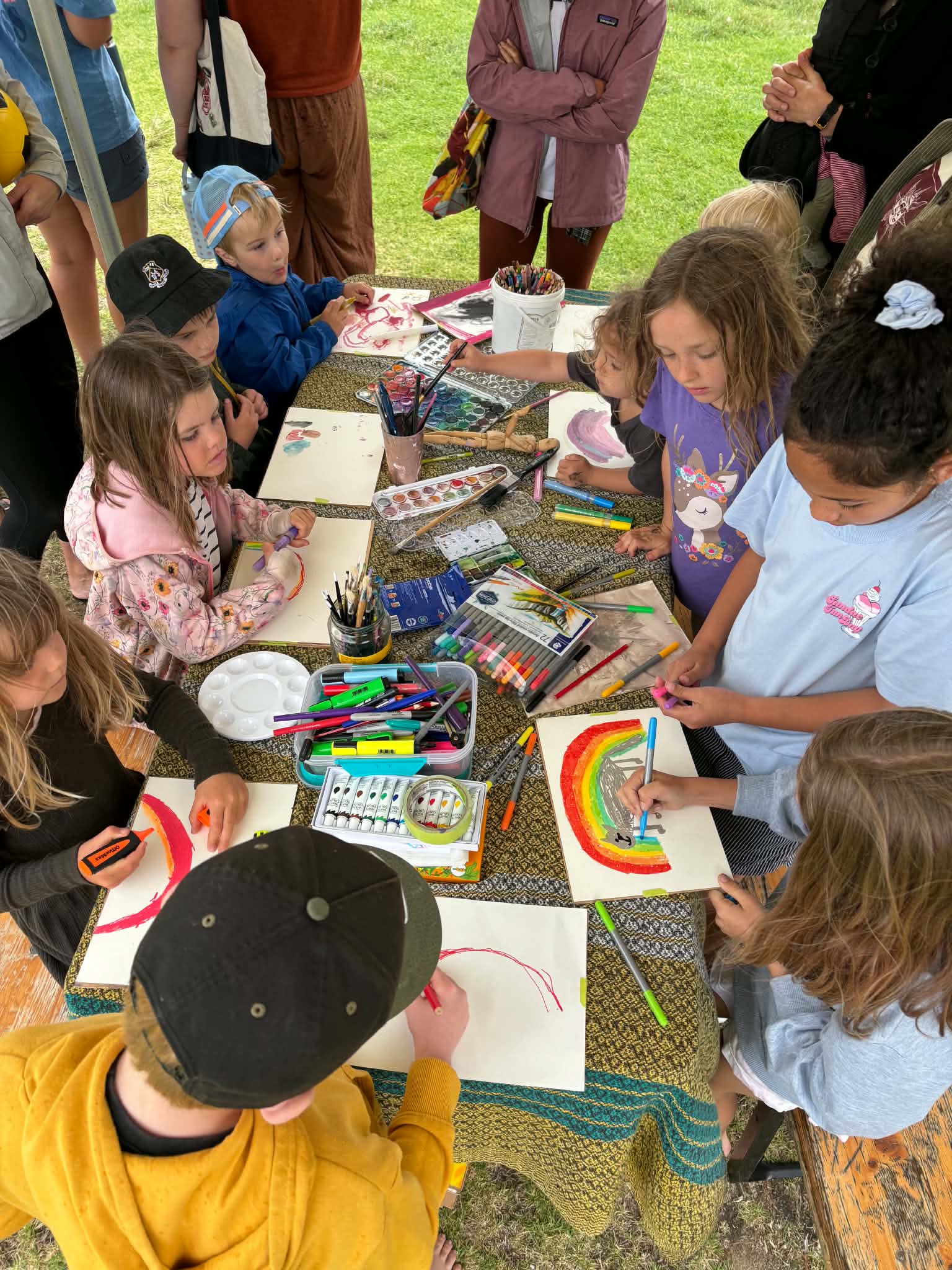 Kids painting vibrant rainbow artwork