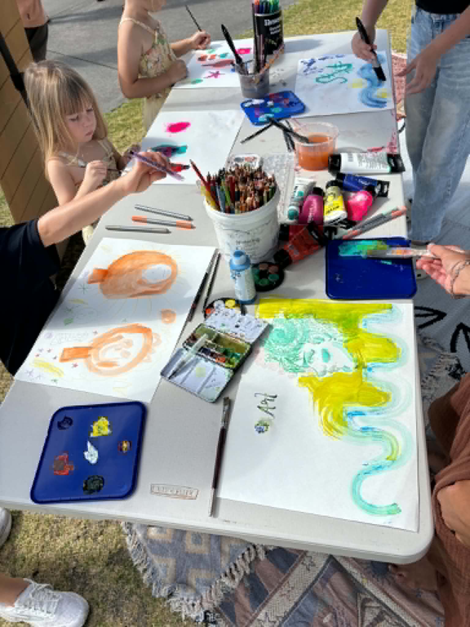 Outdoor painting workshop with colorful supplies