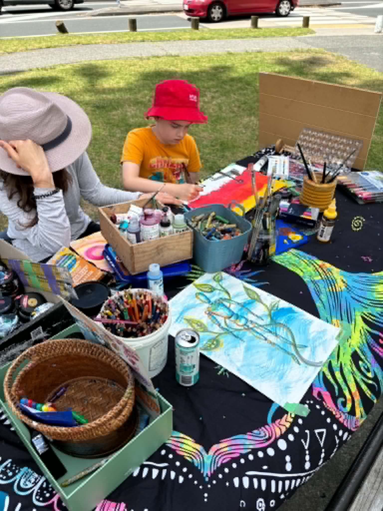 Art supplies spread across a workshop table during a group session
